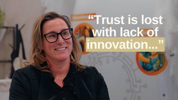 Wendy Zapach, Chief Revenue Officer at Optii, smiling during her interview at The Hospitality Show in Denver, with the quote “Trust is lost with lack of innovation...” displayed beside her.